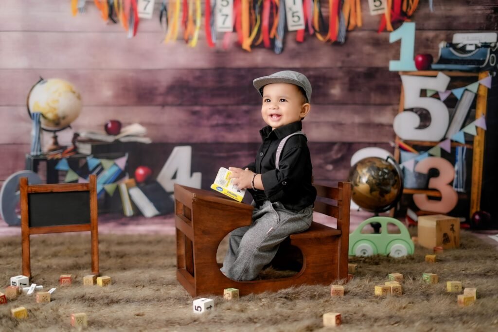 Adorable toddler dressed vintage-style in a school-themed setting with educational props.